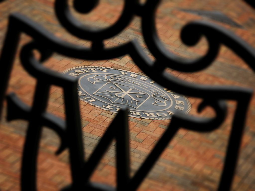 University seal viewed through ironwork WF