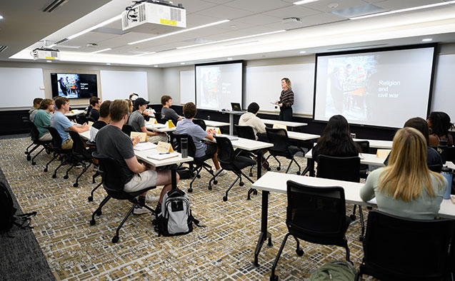 Sarah Lischer’s class spreads out in a new, larger classroom – a combination of a small, underutilized seminar room and a shared office space.
