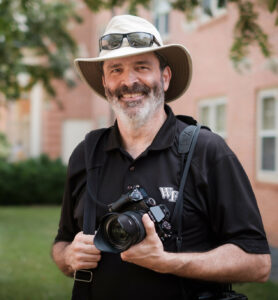 Ken Bennett with camera gear on campus
