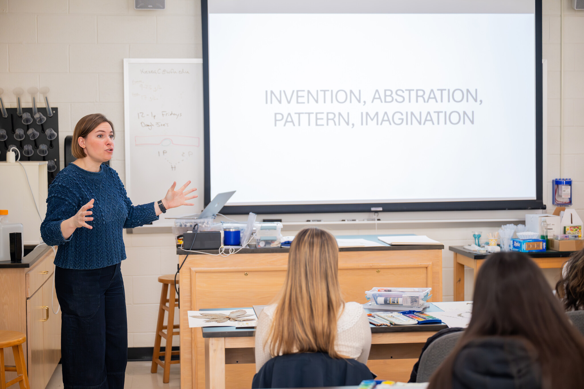 Professor Lydia Smith teaching in front of classroom