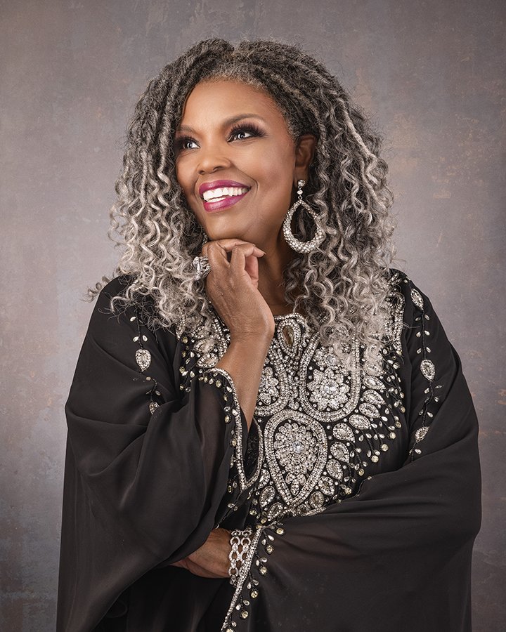 A woman in a black blouse standing for a portrait